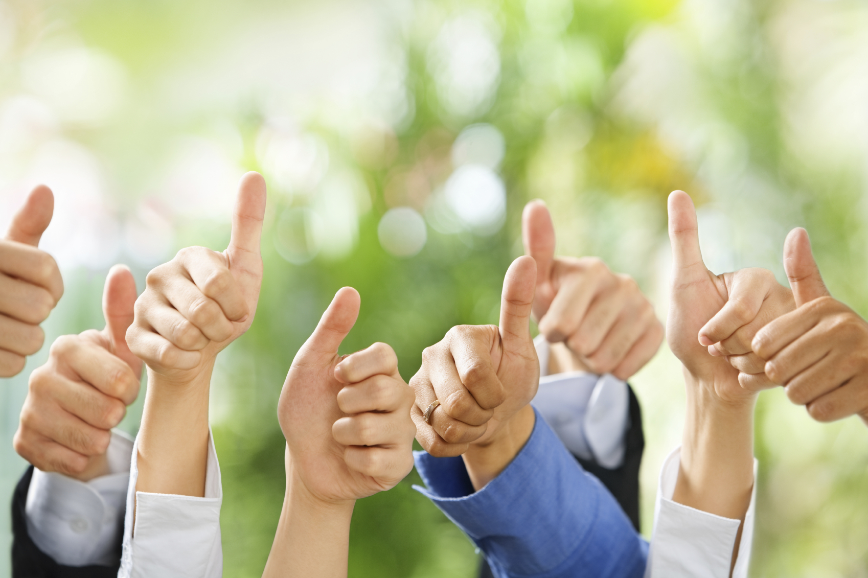 Thumbs up from diverse group of people on green background